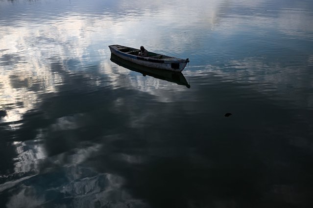 An Iraqi fisherman casts his line in the waters of the Shatt al-Arab river, formed at the confluence of the Tigris and Euphrates rivers, in Iraq's southern city of Basra on December 4, 2024. (Photo by Hussein Faleh/AFP Photo)