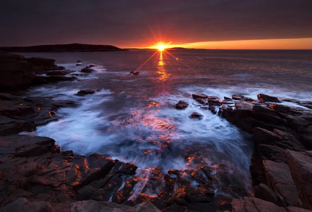 The sun's rays strike the rocky coast of Acadia National Park, in Maine, Thursday, May 2, 2013. (Photo by Robert F. Bukaty/AP Photo)