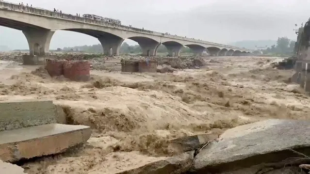 A general view of strong currents in the Chakki river following heavy rains in Kangra, Himachal Pradesh, India on August 20, 2022 in this screen grab obtained from a video. (Photo by ANI via Reuters)