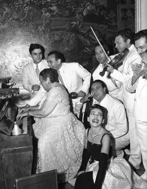 Elsa Maxwell plays the piano during party in Venice, September 3, 1957. Maria Meneghini Callas, in whose honor the ball was given, sits in low corner right foreground, listening, while orchestra members are standing round. (Photo by Jim Pringle/AP Photo)