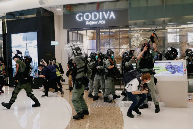 Riot police raise their pepper spray projectile inside a shopping mall as they disperse anti-government protesters during a rally, in Hong Kong, China on May 10, 2020. (Photo by Tyrone Siu/Reuters)