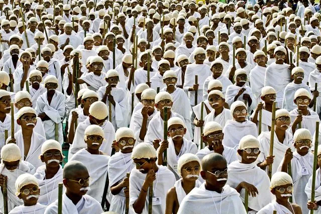 Children dressed as Mahatma Gandhi wait for the start of a rally against violence to mark the birth anniversary of Gandhi in Ahmadabad, India, Oktober 2, 2012. (Photo by Ajit Solanki/Associated Press)
