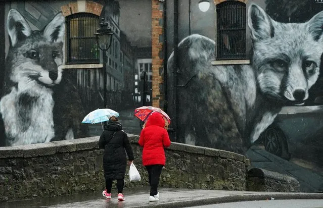 People walk on Binn Bridge, Drumcondra, on a wet and windy day in Dublin on Friday, September 30, 2022. (Photo by Brian Lawless/PA Wire Press Association)