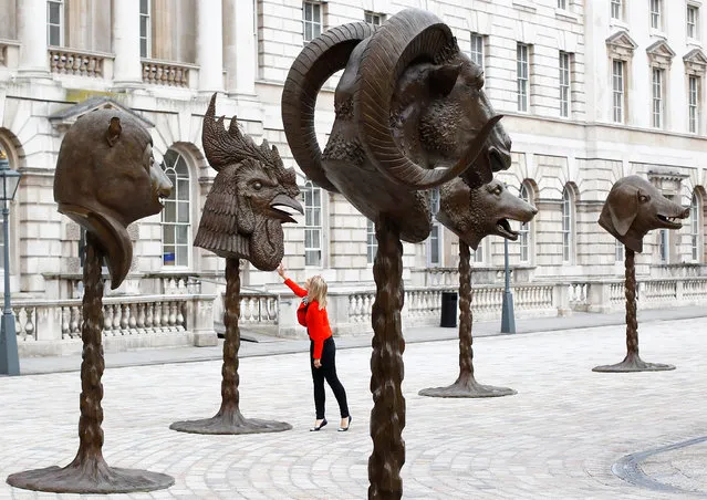 A visitor looks at Ai Weiwei's “Circle of Animals/Zodiac Heads” at Somerset House in London May 11, 2011. (Photo by Andrew Winning/Reuters)