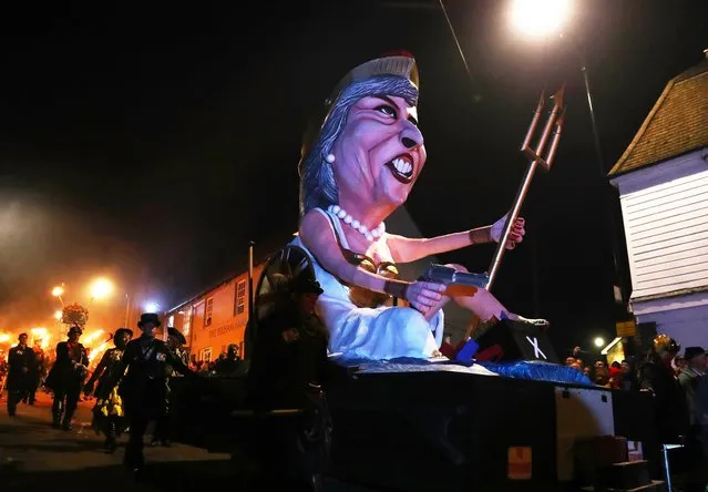 Participants carrying torches march during the traditional Bonfire Celebrations in Lewes, Britain, 04 November 2017. Lewes holds Britain's largest Bonfire night celebrations. The event marks Guy Fawkes Night and the uncovering of the Gunpowder Plot in 1605 and commemorates the memory seventeen Protestant martyrs from the town who were burned at the stake. Thousands gather with flaming torches to march through the street and burn effigies. (Photo by Neil Hall/EPA/EFE)