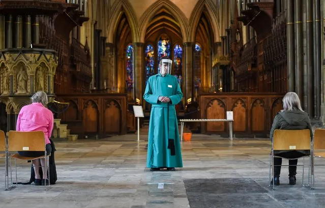 The Very Reverend Nicholas Papadopulos, Dean of Salisbury, welcomes visitors to the Cathedral on June 15, 2020 in Salisbury, United Kingdom. The British government have relaxed coronavirus lockdown laws significantly from Monday June 15, allowing zoos, safari parks and non-essential shops to open to visitors. Places of worship will allow individual prayers and protective facemasks become mandatory on London Transport. (Photo by Finnbarr Webster/Getty Images)