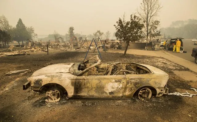 Burned out remains of a vehicle and swing set scorched by the Valley Fire line Jefferson St. in Middletown, California September 13, 2015. (Photo by Noah Berger/Reuters)