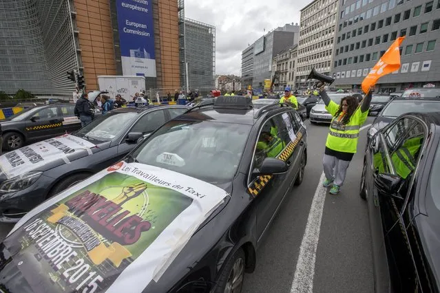 Taxi drivers from all over Europe line a street during a protest against online ride-sharing company Uber, in central Brussels, Belgium, September 16, 2015. (Photo by Yves Herman/Reuters)