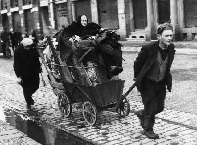 Grandmother sits on top of the household goods in France on November 23, 1944, as a French family return to their home after the liberation of Metz. (Photo by AP Photo)