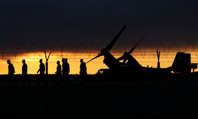 U.S. Marines walk past a MV-22 Osprey, as sun rises before the visit of U.S. Vice President JD Vance at Marine Corps Base Quantico, in Quantico, Virginia on March 26, 2025. (Photo by Kevin Lamarque/Reuters)