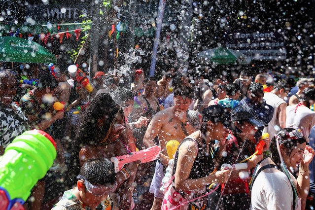 Revellers play with water as they celebrate the Songkran holiday, which marks the Thai New Year, in Bangkok, Thailand, on April 13, 2025. (Photo by Chalinee Thirasupa/Reuters)