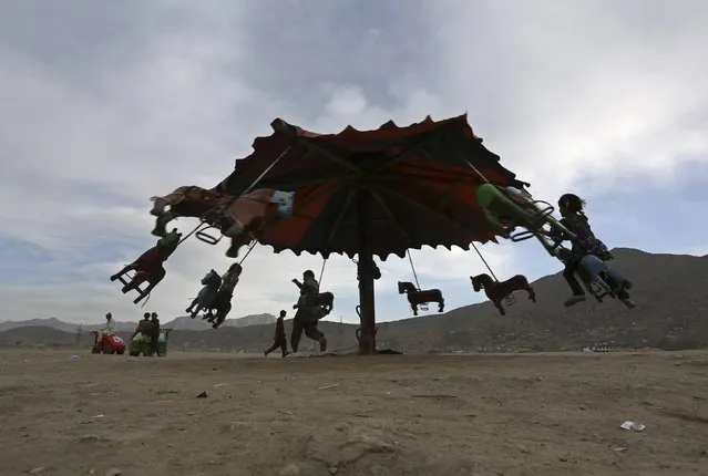 Afghan children play on a swing at an old part of Kabul April 9, 2014. (Photo by Omar Sobhani/Reuters)