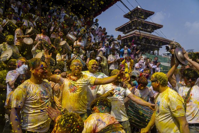 Nepalese people throw colors on each other as they celebrate Holi, the Hindu festival of colors at Basantapur Durbar Square in Kathmandu, Nepal, Thursday, March 13, 2025. (Photo by Niranjan Shrestha/AP Photo)