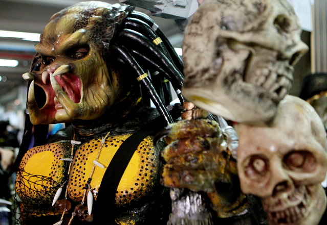 A costume of Predator on display during the 6th annual Leisure and Fantasy Convention (SOFA 2014) in Bogota, Colombia, October 18, 2014. Since 2009, fans of video games, science fiction literature, cosplay, manga and comics gather in the Colombian capital to attend the trade fair. (Photo by Leonardo Munoz/EPA)