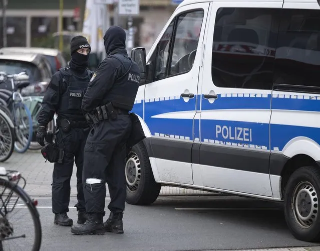Police officers stand by a searched property in Frankfurt during a raid against so-called “Reich citizens” in Frankfurt, Germany, Wednesday, December 7, 2022. Thousands of police carried out a series of raids across much of Germany on Wednesday against suspected far-right extremists who allegedly sought to overthrow the state by force. Federal prosecutors said some 3,000 officers conducted searches at 130 sites in 11 of Germany's 16 states against adherents of the so-called Reich Citizens movement. Some members of the grouping reject Germany's postwar constitution and have called for the overthrow of the government. (Photo by Boris Roessler/dpa via AP Photo)