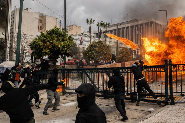 Protesters clash with riot police on the sidelines of a rally as part of a general strike called by unions to mark the second anniversary of Tempi railway collision in February 2023, in front of the Greek parliament, in Athens on February 28, 2025. The unions have called for a general strike in the private and public sectors, which will particularly affect transport, with protest planned in more than 200 cities in Greece. About 300.000 demonstrators demand answers on the exact causes of this head-on collision between two trains, the country's worst rail tragedy, that left 57 dead on February 28, 2023. (Photo by Angelos Tzortzinis/AFP Photo)