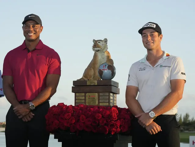Tiger Woods, left, and Viktor Hovland, of Norway, pose for a photo after he winning the Hero World Challenge PGA Tour at the Albany Golf Club, in New Providence, Bahamas, Sunday, December 4, 2022. (Photo by Fernando Llano/AP Photo)