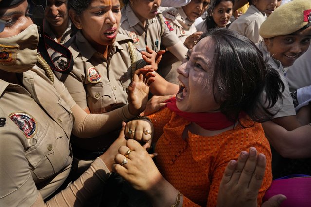A member of Aam Admi Party, or Common Man's Party, screams as she is detained by the police during a protest against the arrest of their party leader Arvind Kejriwal in New Delhi, India, Tuesday, March 26, 2024. Indian police have detained dozens of opposition protesters and prevented them from marching to Prime Minister Narendra Modi’s residence to demand the release of their leader and top elected official of New Delhi who was arrested last week in a liquor bribery case. (Photo by Manish Swarup/AP Photo)
