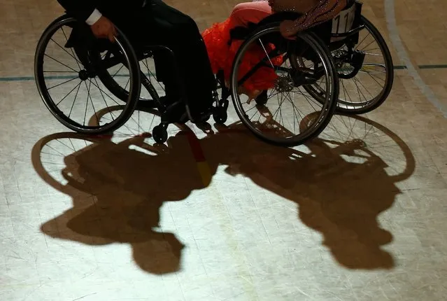 Shadow cast by a pair dancing on wheelchairs during IPC Wheelchair Dance Sport European Championships in  Lomianki near Warsaw, November 9, 2014. (Photo by Kacper Pempel/Reuters)