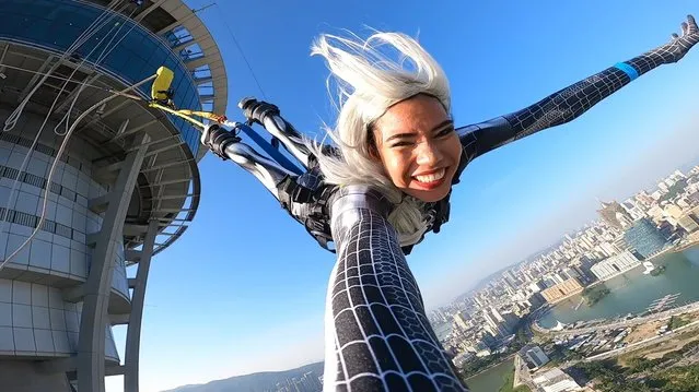 This picture taken on November 2018 shows a person taking part in a 233meters / 764feet high bungee jump off the Macau Tower in Macau, the highest commercial bungee jump in the world, according to Guinness World Records. (Photo by Skypark Macau Tower by AJ Hackett/Facebook)