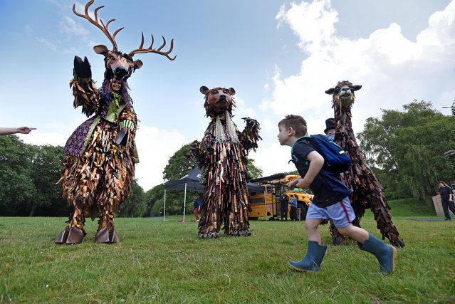 Asa Bentley-Simon, aged 3, watches characters from Statuesque, a walkabout act inspired by statues from the parks of Bradford, UK make their debut in Bowling Park on Saturday, 14 June, 2025 as part of the Bradford 2025 UK City of Culture celebrations. (Photo by Asadour Guzelian)