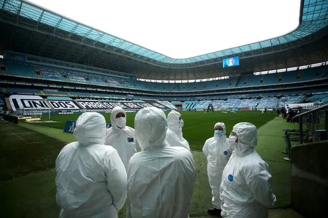 General view of staff wearing personal protective equipment (PPE) inside the stadium Arena do Gremio before the match Gremio v Fortaleza following the outbreak of the coronavirus disease  in Porto Alegre, Brazil on September 13, 2020. (Photo by Diego Vara/Reuters)