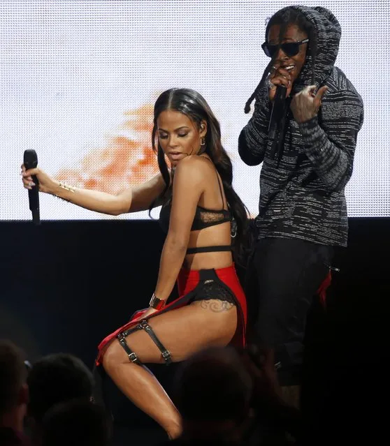 Lil Wayne performs “Lets Start a Fire” with Christina Milian during the 42nd American Music Awards in Los Angeles, California November 23, 2014. (Photo by Mario Anzuoni/Reuters)