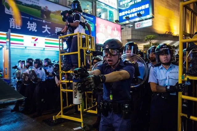 Riot police use tear spray during clash with protesters at Mong Kok on November 25, 2014 in Hong Kong. The Mong Kok protest site is scheduled for clearance by baliffs this week after Hong Kong's high court authorized police to arrest protesters who obstruct bailiffs on the three interim restraining orders. (Photo by Lam Yik Fei/Getty Images)