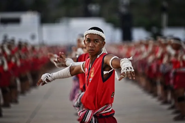 Muay Thai fighters perform the traditional Wai Kru ceremony during a festival for the Thai martial art in Rajabhakti Park in Hua Hin on February 6, 2023, as some 3,360 exponents gathered in an attempt to break the Guinness World Record for the most people taking part in the Wai Kru ritual at once. (Photo by Lillian Suwanrumpha/AFP Photo)