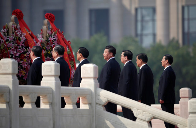 Chinese President Xi Jinping (C), and other top leaders (L-R) Wang Qishan, Yu Zhengsheng, Li Keqiang, Zhang Dejiang, Liu Yunshan, Zhang Gaoli attend a tribute ceremony in front of the Monument to the People's Heroes at Tiananmen Square, ahead of National Day marking the 67th anniversary of the founding of the People's Republic of China in Beijing, China, September 30, 2016. (Photo by Jason Lee/Reuters)