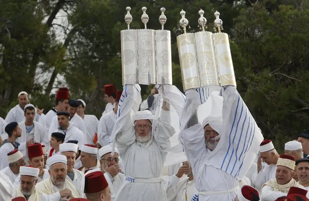 Members of the Samaritan community take part in a traditional pilgrimage marking the holiday of Sukkot, or Feast of Tabernacles, atop Mount Gerizim near the West Bank city of Nablus early October 27, 2015. The Samaritans, who trace their roots to the northern Kingdom of Israel in what is now the northern West Bank, observe religious practices similar to those of Judaism. (Photo by Abed Omar Qusini/Reuters)