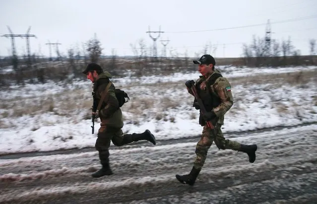 Pro-Russian separatists from the Chechen “Death” battalion run during a training exercise in the territory controlled by the self-proclaimed Donetsk People's Republic, eastern Ukraine, December 8, 2014. (Photo by Maxim Shemetov/Reuters)
