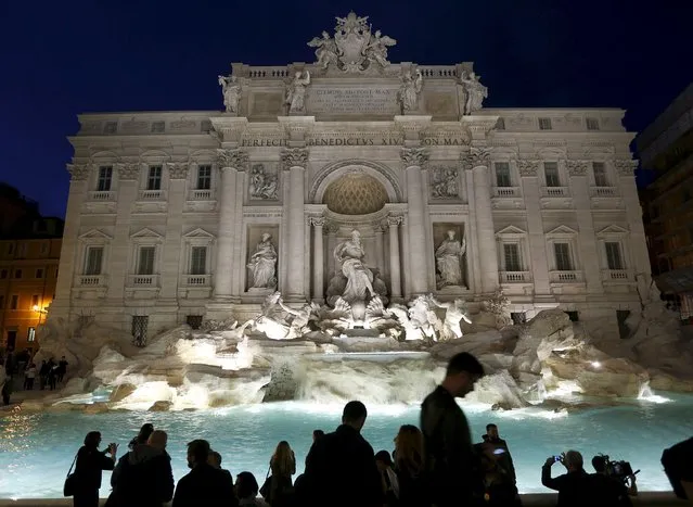 People take pictures during an opening ceremony of Rome's Trevi Fountain after being restored, November 3, 2015. Italian fashion house Fendi takes down the plastic barriers that surrounded Rome's Trevi Fountain for 16 months as the stone rendering of Tritons underwent the most drastic renovation in its 252-year history. (Photo by Alessandro Bianchi/Reuters)