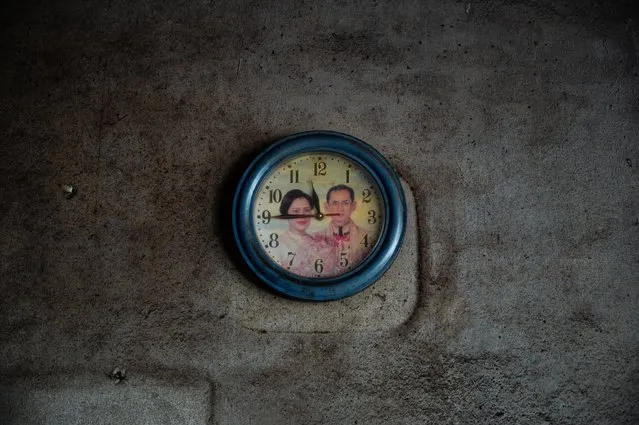 A faded image of Thailand's late King Bhumibol Adulyadej (Rama IX) and Queen Sirikit decorates a clock face in an old house on December 04, 2020 in Ranong, Thailand. Southern Thailand has long been seen as a stronghold of Royalist support. Reverence for the present and past kings is high, and publicly visible all across the southern provinces. Portraits of the royal family saturate public and private spaces in the region, a reminder that despite ongoing protests in the capital, support for existing institutions remains high in some parts of the country, and especially in the south. (Photo by Sirachai Arunrugstichai/Getty Images)