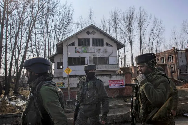 Indian army soldiers walk near the site of a gun battle on the outskirts of Srinagar, Indian controlled Kashmir, Wednesday, December 30, 2020. A gun battle between rebels and government forces overnight killed three rebels on the outskirts of Srinagar on Wednesday, officials said. (Photo by Dar Yasin/AP Photo)