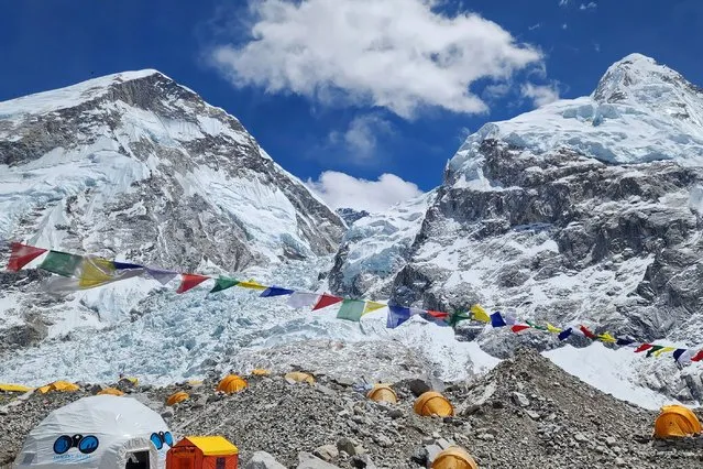 Tents of mountaineers are pictured at the Everest base camp in the Mount Everest region of Solukhumbu district, on April 12, 2023. A search was underway for three Nepali climbers who fell into a crevasse while ascending Everest on April 12, the first such accident on the world's highest mountain this climbing season. (Photo by Ang Tashi Sherpa/AFP Photo)