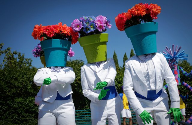Performers dressed with flower pots on their heads perform during a media preview of the Pacific National Exhibition Fair in Vancouver, British Columbia, Canada, August 15, 2024. Marking its 114th year, the Pacific National Exhibition (PNE) Fair, one of the longest running events in Canada, runs from Aug. 17 to Sept. 2 here this year. (Photo by Xinhua News Agency/Rex Features/Shutterstock)