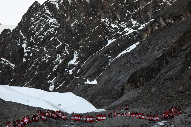 Pablitos descend a rock face where previously there was ice, after a ceremony during the annual Qoyllur Rit'i festival on May 29, 2018 in Ocongate, Peru. (Photo by Dan Kitwood/Getty Images)