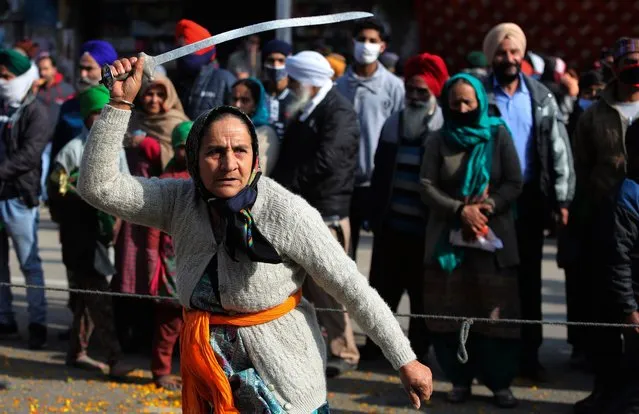 An Indian Sikh woman displays traditional martial art skills during a religious procession ahead of the birth anniversary of Guru Gobind Singh in Jammu, India, Monday, January18, 2021. The tenth Sikh guru's birth anniversary will be marked on January 20. (Photo by Channi Anand/AP Photo)