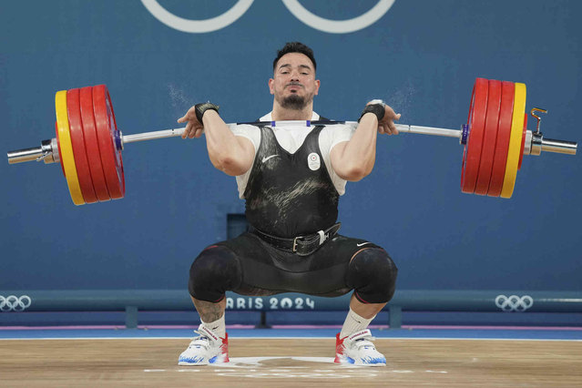 Ramiro Mora Romero of Refugee Olympic Team competes during the men's 102kg weightlifting event, at the 2024 Summer Olympics, Saturday, August 10, 2024, in Paris, France. (Photo by Kin Cheung/AP Photo)