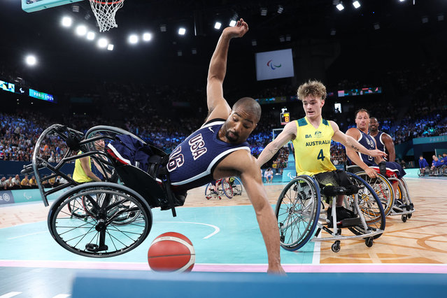 Trevon Jenifer of Team United States falls as Eithen Leard of Team Australia looks on during the Preliminary Round Group B match between Team Australia and Team United States on day four of the Paris 2024 Summer Paralympic Games at Bercy Arena on September 01, 2024 in Paris, France. (Photo by Michael Steele/Getty Images)