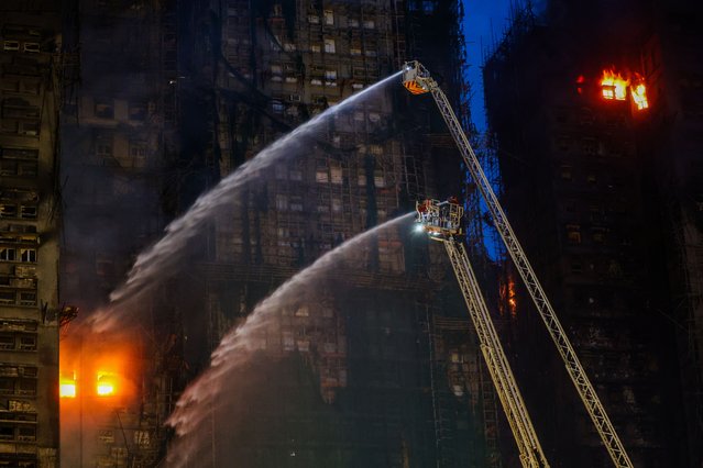 Rescue efforts continue at the Wang Fuk Court residential buildings, in Tai Po, Hong Kong, on November 27, 2025. At least 55 people have been found dead in fire accident according to a press briefing by the city's fire and rescue service. Search and rescue efforts are underway to search for possible survivors in the buildings affected by the fire. (Photo by Daniel Ceng/Anadolu via Getty Images)