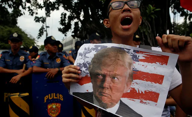 A member of student activist group, League of Filipino Students, displays an image of U.S. President-elect Donald Trump as he chants anti-U.S. slogans during a rally outside the U.S. embassy in Manila, Philippines November 10, 2016. (Photo by Erik De Castro/Reuters)