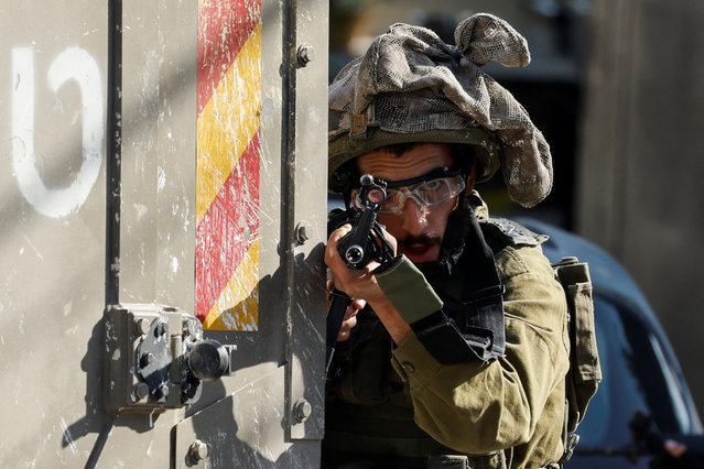 An Israeli soldier holds a rifle near a hospital in Tubas, in the Israeli-occupied West Bank, on December 3, 2024. (Photo by Raneen Sawafta/Reuters)
