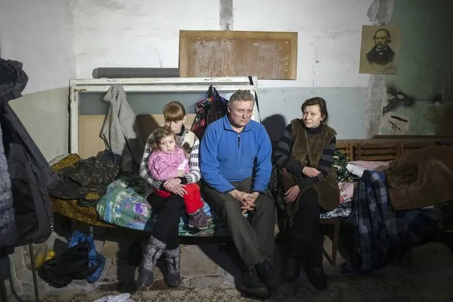 Local residents gather inside a bomb shelter in Debaltseve, Donetsk region, January 30, 2015. Civilians were killed on both sides in heavy fighting in eastern Ukraine on Friday, while an attempt to reopen peace talks in neighbouring Belarus was aborted before it began. In Debaltseve, east of Donetsk, seven civilians were killed on Friday by separatist shelling of their homes, regional police chief Vyacheslav Abroskin said in a Facebook post. (Photo by Maksim Levin/Reuters)