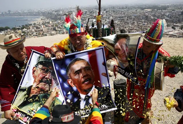 Peruvian shamans holding posters of Cuba's President Raul Castro, U.S. President Barack Obama and Argentinian President Mauricio Macri perform a ritual of predictions for the new year at Morro Solar hill in Chorrillos, Lima, Peru, December 29, 2015. (Photo by Mariana Bazo/Reuters)