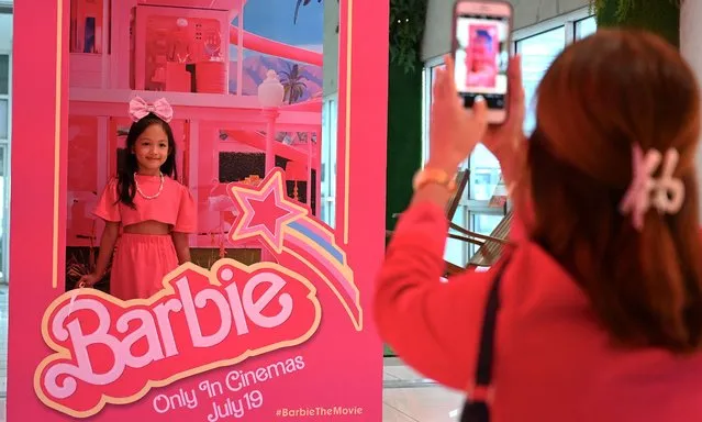 A child poses for a photo inside a life-sized doll box after watching the “Barbie” film at the SM North Edsa in Quezon City on July 19, 2023. (Photo by Jam Sta Rosa/AFP Photo)