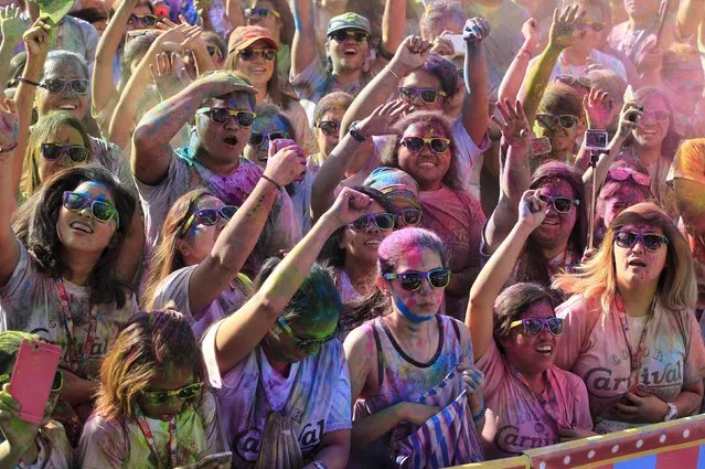 Runners celebrate as they are covered with color powder during a "Color Fun Run" in Manila, Philippines January 3, 2016. (Photo by Romeo Ranoco/Reuters)