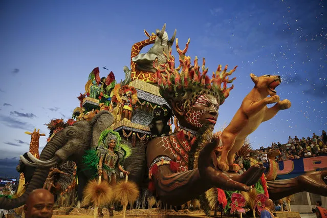 Dancers from the Nene de Vila Matilde samba school perform on a float during a carnival parade in Sao Paulo, Brazil, Saturday, February 14, 2015. (Photo by Andre Penner/AP Photo)