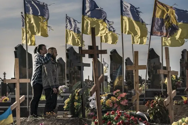 Vladislav Raenko and his girlfriend, visit the gravesite of Raenko's father Vladymyr Andreevych Roenko at a cemetery in Kharvi, Ukriane, Friday, May 13, 2022. Raenko's father Vladymyr died three days after the war started. Russian soldier Vadim Shishimarin was arrested and charged by prosecutors for the civilian's death, which occurred days after Russia invaded Ukraine on Feb. 24. His trial began Friday. (Photo by Ken Cedeno/UPI/Rex Features/Shutterstock)
